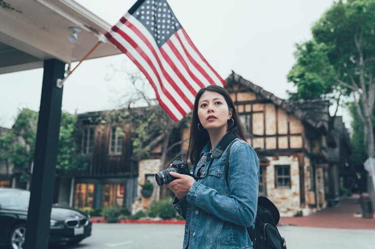 USA Student standing in front of USA Flag